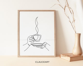 May include: A black and white line drawing of a hand holding a cup of coffee with steam rising from it. The drawing is framed in a light wood frame and is hanging on a white wall.