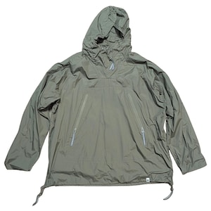 May include: Olive green anorak jacket with a hood and two front zippered pockets. The jacket has a drawstring at the hem and a small logo on the lower right. The anorak is made of a lightweight material.