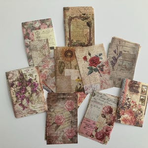 May include: A set of vintage-style paper ephemera featuring floral designs, including roses and other flowers, with a distressed, aged look. The papers are perfect for scrapbooking, card making, and other craft projects.