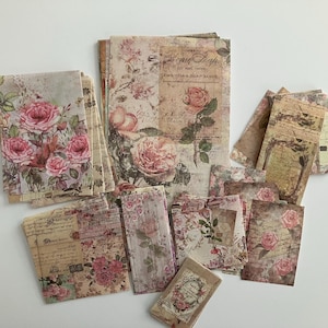 May include: A collection of vintage-style paper sheets with floral designs and text. The sheets feature a variety of patterns, including roses, leaves, and script. The paper is perfect for scrapbooking, card making, and other craft projects.