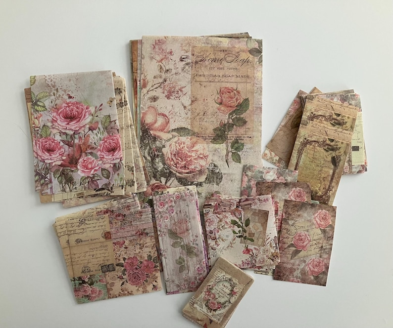 May include: A collection of vintage-style paper sheets with floral designs and text. The sheets feature a variety of patterns, including roses, leaves, and script. The paper is perfect for scrapbooking, card making, and other craft projects.