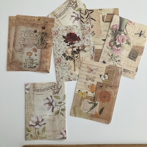 May include: A set of vintage-style paper ephemera featuring floral illustrations and botanical designs. The papers are printed on a cream-colored background with brown and black text. The text includes the words "Herboristerie" and "Florvm Imagines".