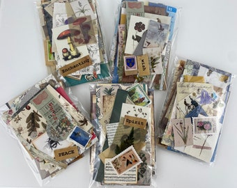 May include: Four clear plastic bags filled with vintage style paper ephemera for scrapbooking or crafting. The bags are labeled "Enchanting", "Wish", "Spirit", and "Peace".