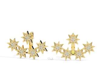 May include: A pair of gold earrings with a cluster of five star-shaped charms, each set with small sparkling diamonds. The earrings are designed to be worn on the upper ear.
