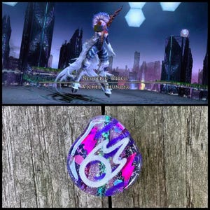 May include: A teardrop-shaped resin pendant featuring a vibrant mix of purple, pink, and blue glitter with iridescent flakes. A prominent white, stylized flame-like emblem is centered on the surface, creating a bold contrast against the colorful background.
