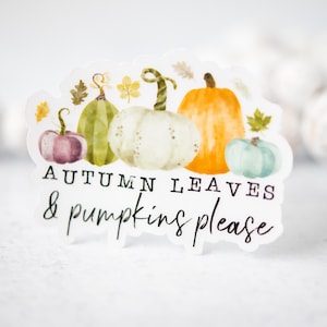May include: A sticker with a watercolor illustration of pumpkins and leaves. The text reads "Autumn Leaves & Pumpkins Please."