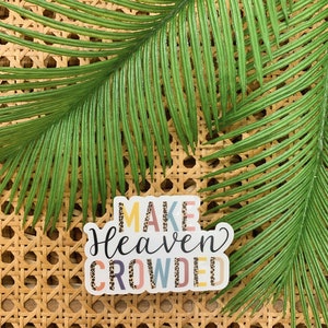 May include: A sticker with the text "Make Heaven Crowded" in colorful letters with a leopard print pattern.