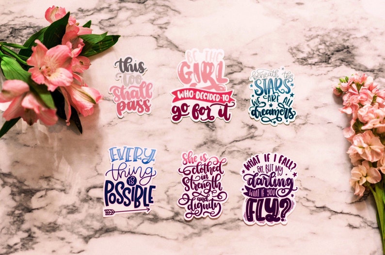 Puede incluir: Conjunto de 8 pegatinas coloridas con citas inspiradoras. Las pegatinas presentan una variedad de fuentes y colores, incluyendo rosa, azul, morado y negro. Las citas incluyen "Esto tambi&eacute;n pasar&aacute;", "S&eacute; la chica que decidi&oacute; ir a por ello", "Bajo las estrellas todos somos so&ntilde;adores", "Todo es posible", "Ella est&aacute; vestida de fuerza y dignidad", "&iquest;Qu&eacute; pasa si me caigo? Oh, pero mi amor, &iquest;y si vuelas?"