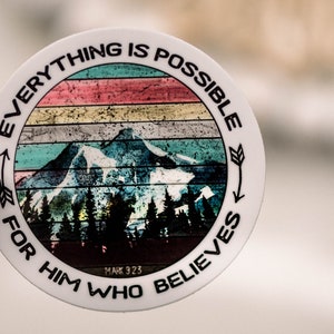 May include: A white round sticker with a colorful mountain scene and the text "Everything is possible for him who believes Mark 9:23".