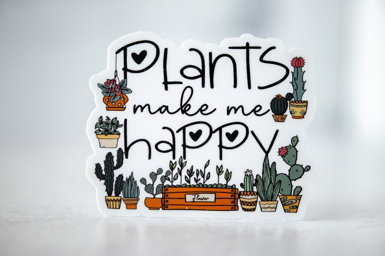 May include: White sticker with black text that reads "Plants make me happy" surrounded by illustrations of potted plants. The plants include cacti, succulents, and leafy plants.