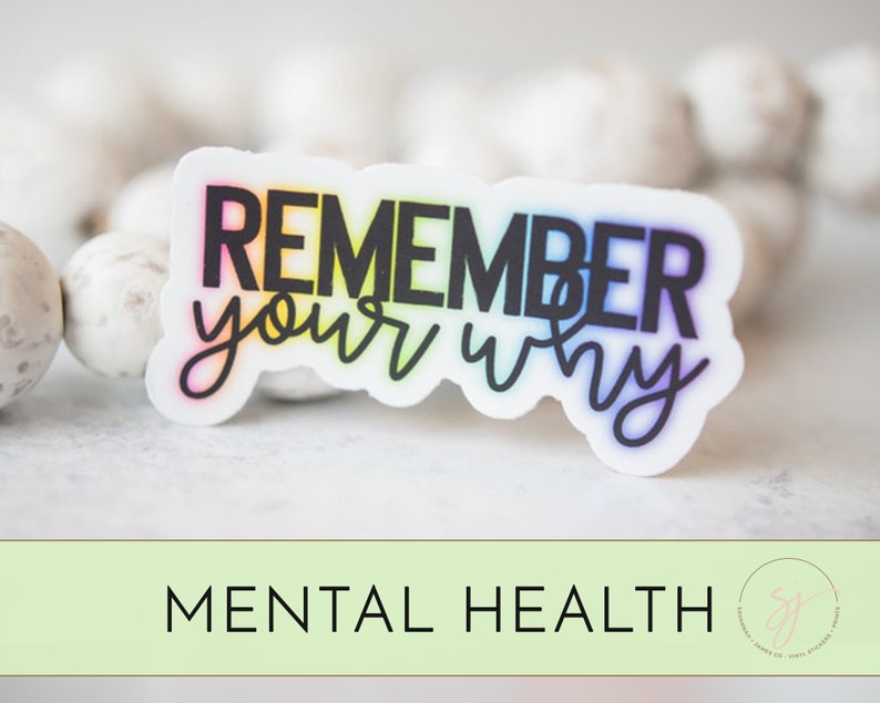 May include: A sticker with the text "Remember your why" in black letters with a rainbow gradient behind the letters. The sticker is on a white background.