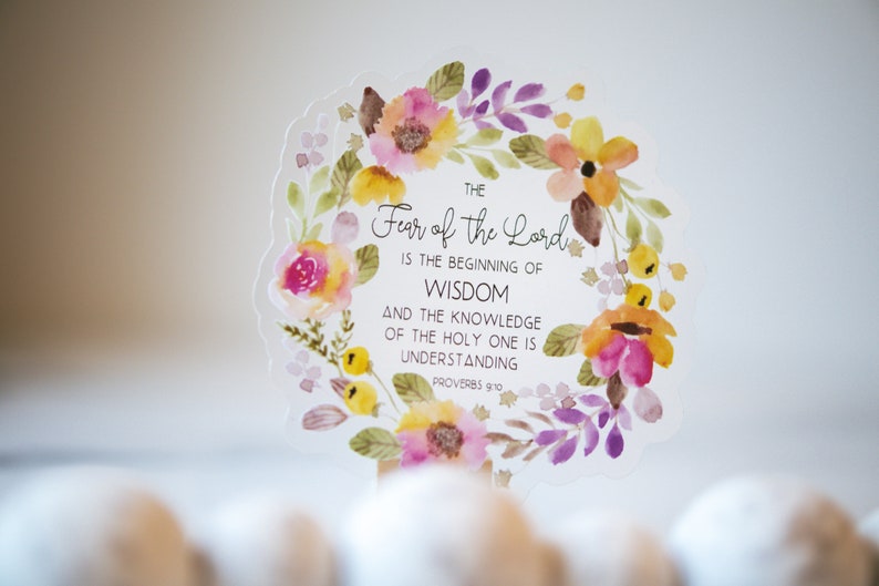 May include: A watercolour floral wreath with a white background and the text "THE Fear of the Lord IS THE BEGINNING OF WISDOM AND THE KNOWLEDGE OF THE HOLY ONE IS UNDERSTANDING PROVERBS 9:10".