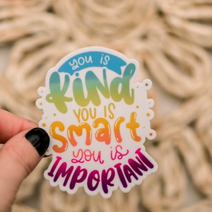 May include: A white sticker with a rainbow gradient design. The sticker says "You is kind. You is smart. You is important."