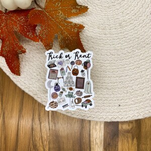 Pu&ograve; includere: Un adesivo bianco con il testo "Trick or Treat" e varie illustrazioni a tema Halloween, tra cui zucche, pipistrelli, caramelle e un fantasma.