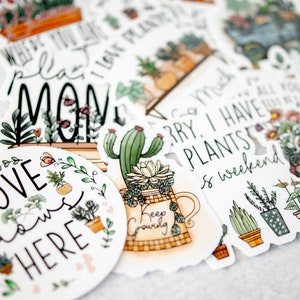 May include: A set of colourful stickers featuring illustrations of plants and pots with various sayings, including "Where you plant love grows", "Sorry I have plants", "Love grows here", and "Keep growing".