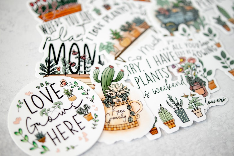 May include: A set of colourful stickers featuring illustrations of plants and pots with various sayings, including "Where you plant love grows", "Sorry I have plants", "Love grows here", and "Keep growing".