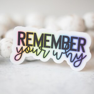 May include: A white sticker with a rainbow gradient behind the text "REMEMBER your why" in black.