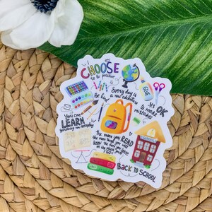 May include: A colorful sticker with a back to school theme. It features a schoolhouse, a backpack, books, pencils, crayons, and a globe. The sticker has the text "Choose to be positive", "Be kind", "You can learn something new everyday", "Every day is a new adventure", "The more you read the more things you will know the more you learn on the places you'll go", "It's OK to make mistakes", and "Back to School".