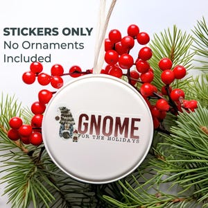 May include: White round sticker with a gnome illustration and the text "Gnome for the Holidays". The sticker is surrounded by red berries and green pine branches.