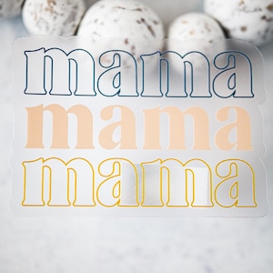 May include: Three layered stickers with the word "mama" in a retro font. The top layer is blue, the middle layer is peach, and the bottom layer is yellow.