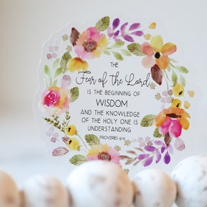 May include: A watercolour floral wreath with a white background and the text "THE Fear of the Lord IS THE BEGINNING OF WISDOM AND THE KNOWLEDGE OF THE HOLY ONE IS UNDERSTANDING PROVERBS 9:10".
