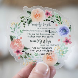 May include: A clear sticker with a floral wreath design and a quote from Isaiah 55:8-9. The quote reads "For My thoughts are not your thoughts, nor are your ways," says the Lord. "For as the heavens are higher than the earth, so are My ways higher than your ways, and My thoughts than your thoughts."