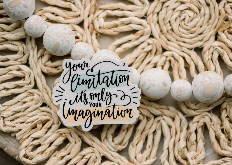 May include: A white sticker with the text "your limitation it's only your imagination" in black script. The sticker has a blue, green, and orange striped background.