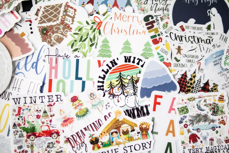 May include: A collection of colorful Christmas stickers featuring various holiday themes, including a gingerbread house, a snowman, a Christmas tree, and a nativity scene. The stickers have text that reads "Have a Holly Jolly Winter", "Chillin' With My S.N.O.W.M.I", "Merry Christmas", "Christmas Time", and "A Very Magical Christmas".