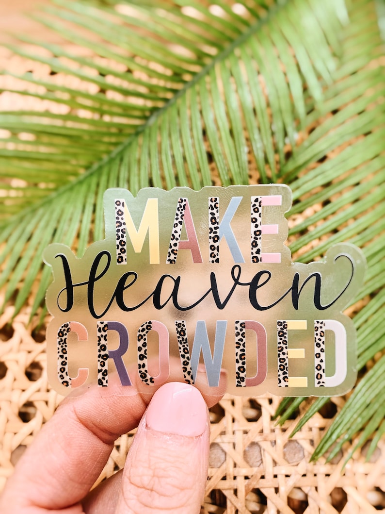 May include: A clear sticker with the text "MAKE HEAVEN CROWDED" in colorful letters with a leopard print pattern.