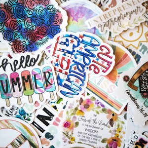 May include: Assortment of colorful stickers with various designs and phrases, including "hello summer", "cute", "entrepreneur", and a heart with the words "let all that you do be done in love" and "Corinthians 16:14".