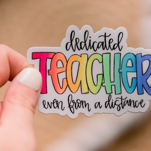 May include: A rainbow-colored sticker with the text "dedicated teacher even from a distance".