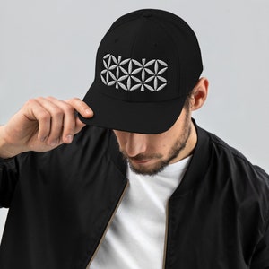 May include: A black trucker hat with a white embroidered flower of life design.