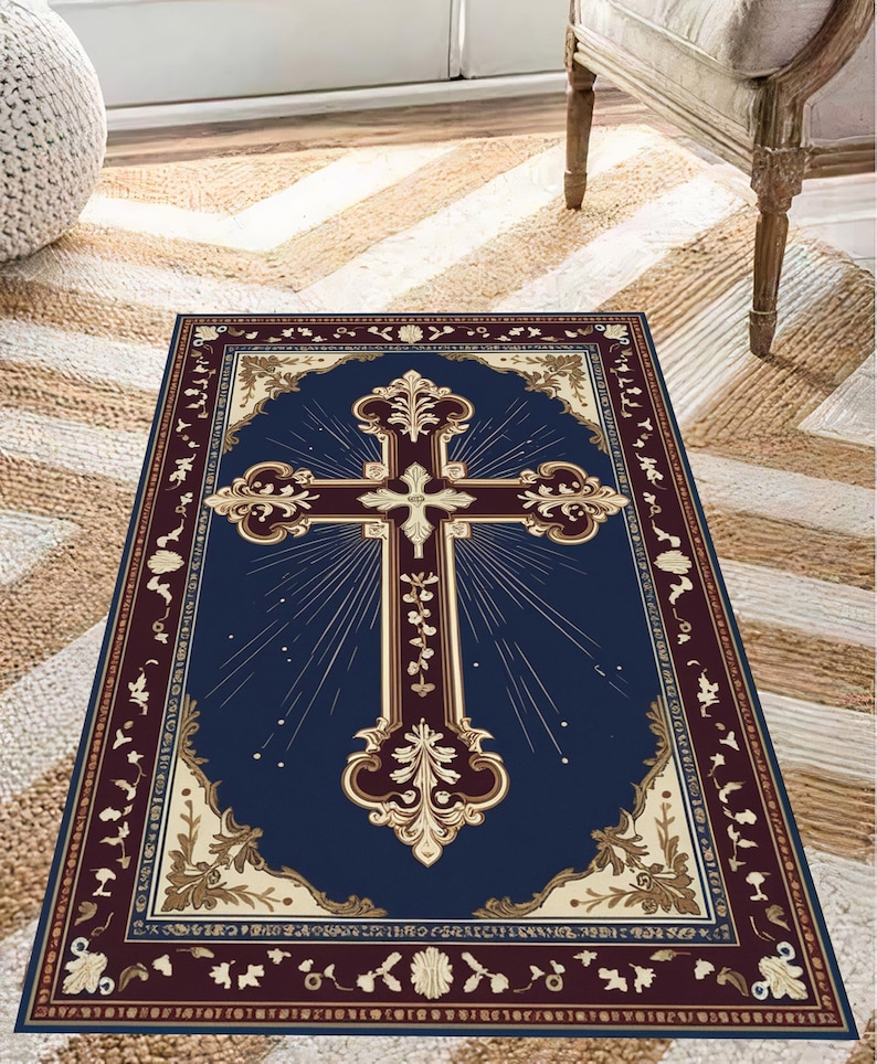 May include: A navy blue rug with a gold and white cross design. The cross is surrounded by a decorative border of gold and white floral patterns. The rug has a burgundy border.