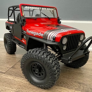 May include: Red Jeep Renegade toy car with black wheels, a black roll cage, and a black front bumper with a black bull bar. The car has a white and silver stripe on the hood and the words "Genright Off Road" on the windshield.
