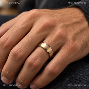 May include: A gold-toned metal ring with a brushed matte finish and polished beveled edges. The band features a flat profile and a smooth, uniform surface. The text ETSY: SHOESICAL is visible in the corners of the image.