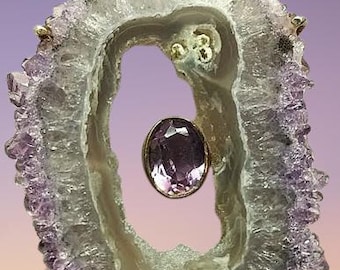 Amethyst crystal pendant with Amethyst stone in the middle. Sterling silver box and prongs.