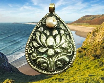 Coin Silver handmade pendant. There is a small 8mm natural pearl in the upper end