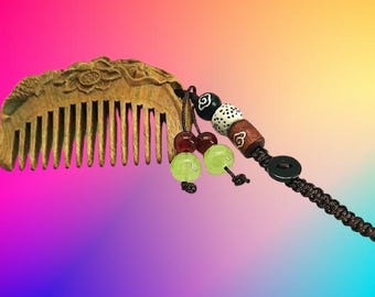 A highly collectable mini vintage Wood Comb and decorated with a beaded pigtail.