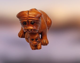 French Bulldog Mom with her Pup. NETSUKE piece is a vintage item, a very small hand carved wooden art piece. It is also highly collectable.