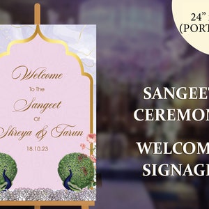 May include: A portrait-oriented welcome sign for a Sangeet ceremony, measuring 24" x 36". The sign features a pink background with gold accents and a decorative arch. It includes the text "Welcome to the Sangeet of Shreya & Tarun 18.10.23" and peacock illustrations.