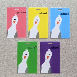 May include: Five colorful cards with a white cartoon bird on each. The bird is looking over its shoulder and the text "mine?" is printed on each card.
