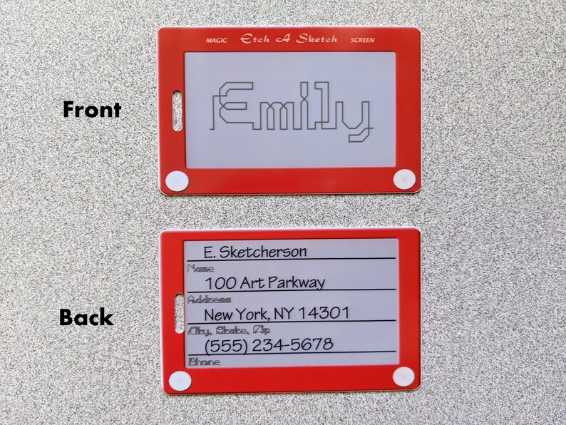 May include: Red plastic Etch A Sketch toy with a white screen. The screen shows the name "Emily" drawn in black lines. The back of the toy has a white screen with black text that reads "E. Sketcherson", "Name", "100 Art Parkway", "Address", "New York, NY 14301", "City, State, Zip", "(555) 234-5678", "Phone".