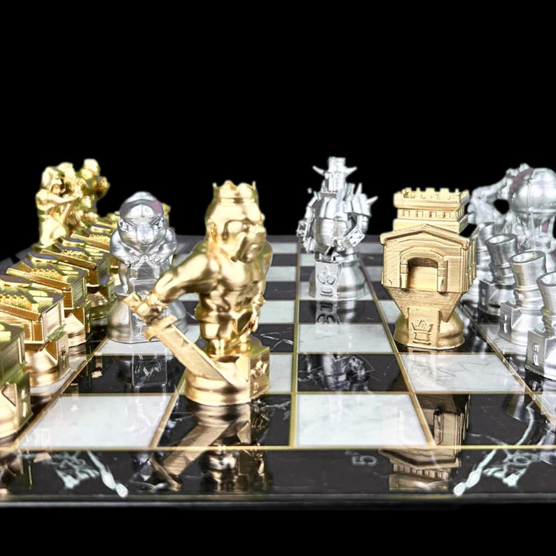 May include: A gold and silver chess set with pieces arranged on a black and white marble chessboard. The pieces are stylised and feature a medieval theme.