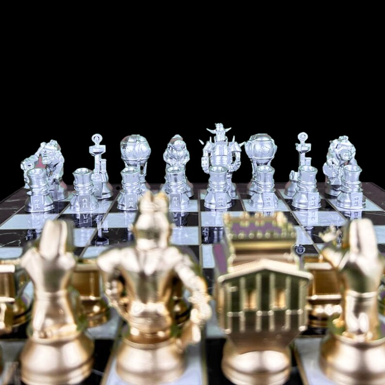 May include: A silver chess set with pieces in the shape of robots and other futuristic designs. The pieces are arranged on a black and white chequered board. The board is made of wood and has a polished finish.