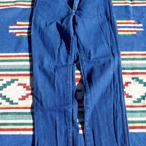 May include: A pair of dark blue denim jeans with a straight leg fit.