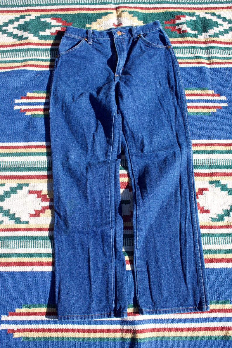 May include: A pair of dark blue denim jeans with a straight leg fit.