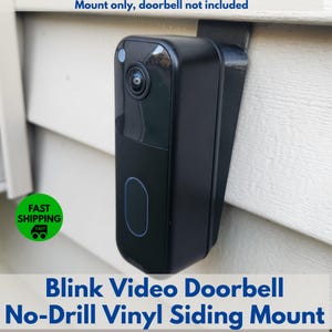 May include: Black Blink video doorbell mount for vinyl siding. The mount is designed for a no-drill installation. The text on the image reads "Blink Video Doorbell No-Drill Vinyl Siding Mount".