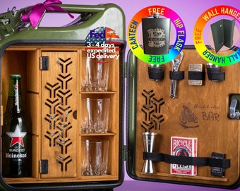 May include: A green metal bar cabinet shaped like a gas can with a wooden interior. The cabinet has a shelf for glasses and a small door. The cabinet is open and shows a bottle of Heineken beer, a jigger, a deck of cards, and a bottle opener.