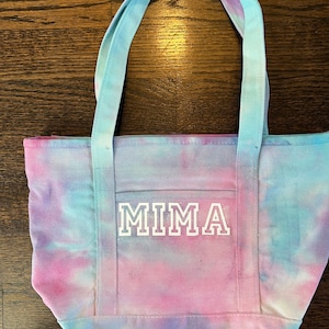 Blue, purple and pink tie dye shoulder tote,  beach bag in cotton canvas with front pockets and black lettering of choice on front