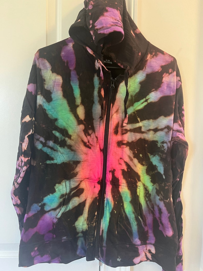 May include: Black tie-dye zip-up hoodie with a rainbow swirl pattern.